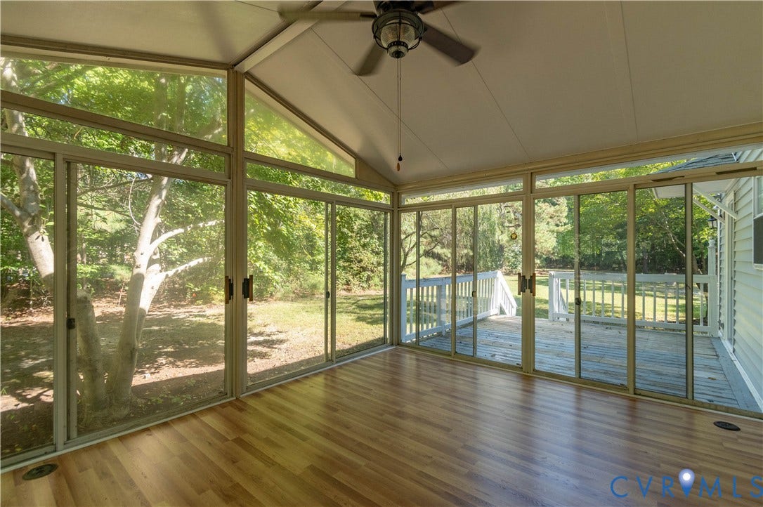 9045 Blounts Corner Road, Smithfield, VA 23430 Screened-in enclosure featuring a vaulted ceiling, wood-finish flooring, ceiling fan, and sliding glass walls with exterior deck access