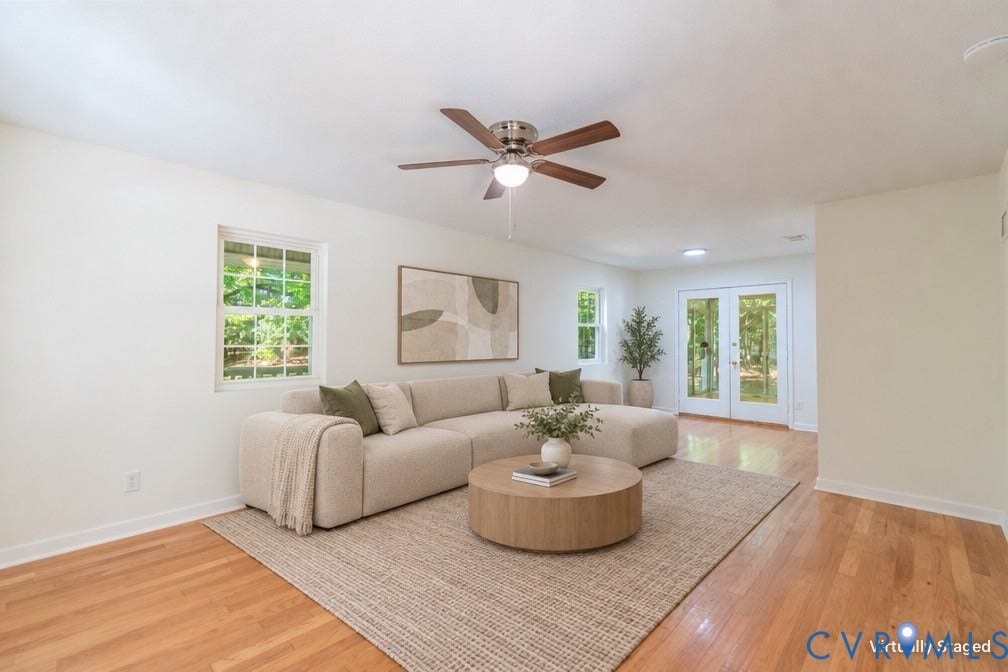 9045 Blounts Corner Road, Smithfield, VA 23430 Living area featuring wood-finish flooring, a ceiling fan with integrated lighting, multiple windows, and a set of glass-paned double doors