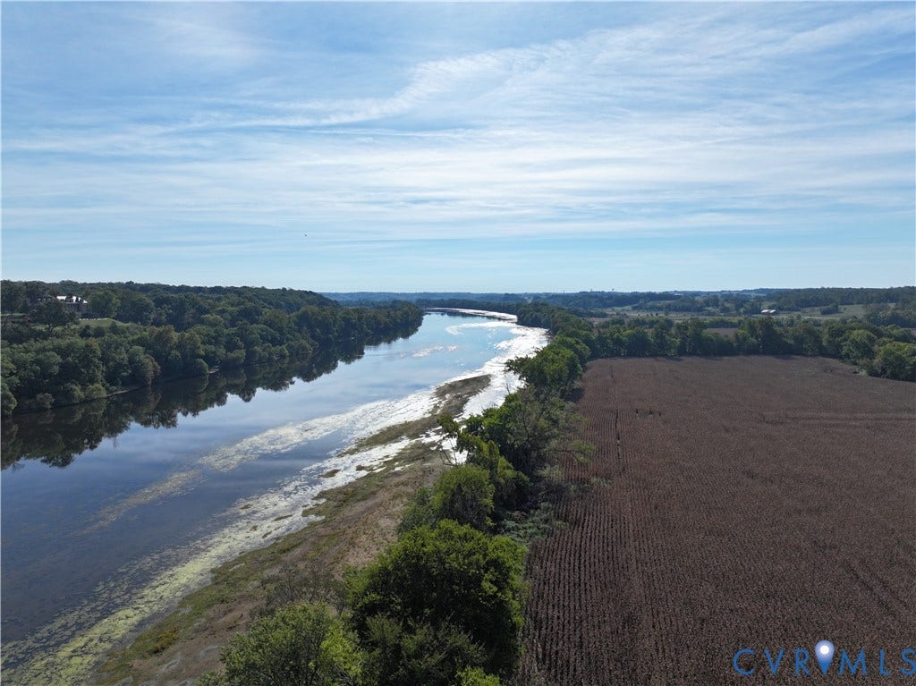 0 Old River Trail, Powhatan, VA 23139 Aerial perspective featuring a sprawling agricultural field, dense mature tree line, and extensive river frontage