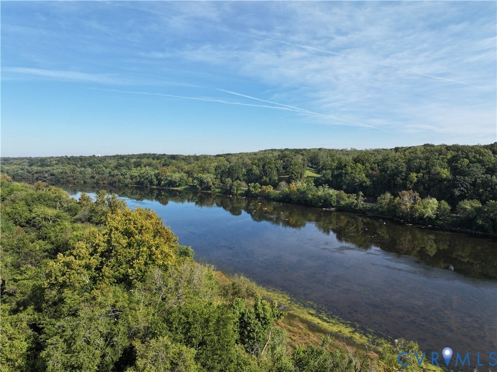 0 Old River Trail, Powhatan, VA 23139 Expansive water frontage featuring a wide river, mature riparian trees, and dense natural foliage