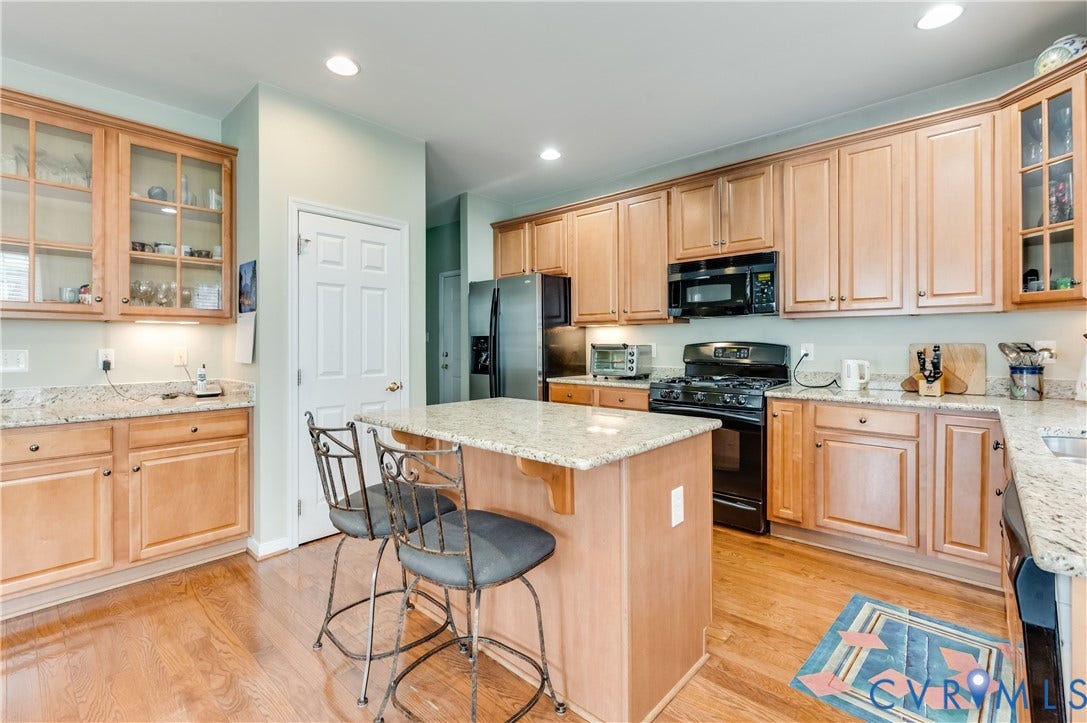 704 Taylors Hill Court, Manakin Sabot, VA 23103 Wood-finish flooring, ample cabinetry, granite countertops, built-in microwave, and recessed lighting