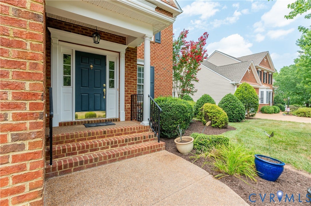 704 Taylors Hill Court, Manakin Sabot, VA 23103 Brick exterior with a prominent blue entry door and sidelights