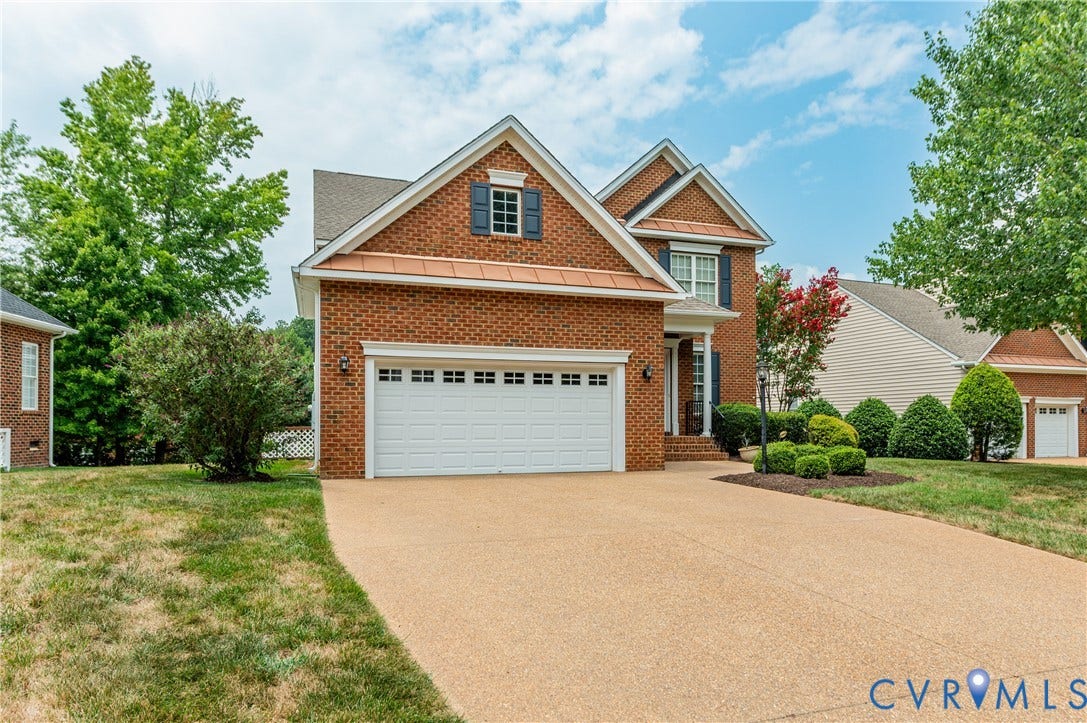 704 Taylors Hill Court, Manakin Sabot, VA 23103 Brick facade residence featuring an attached two-car garage, an additional single-car garage, and a textured driveway