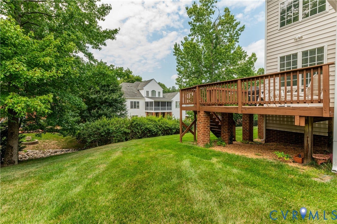 704 Taylors Hill Court, Manakin Sabot, VA 23103 Expansive green lawn with a multi-level wood deck featuring a railing system and brick column supports