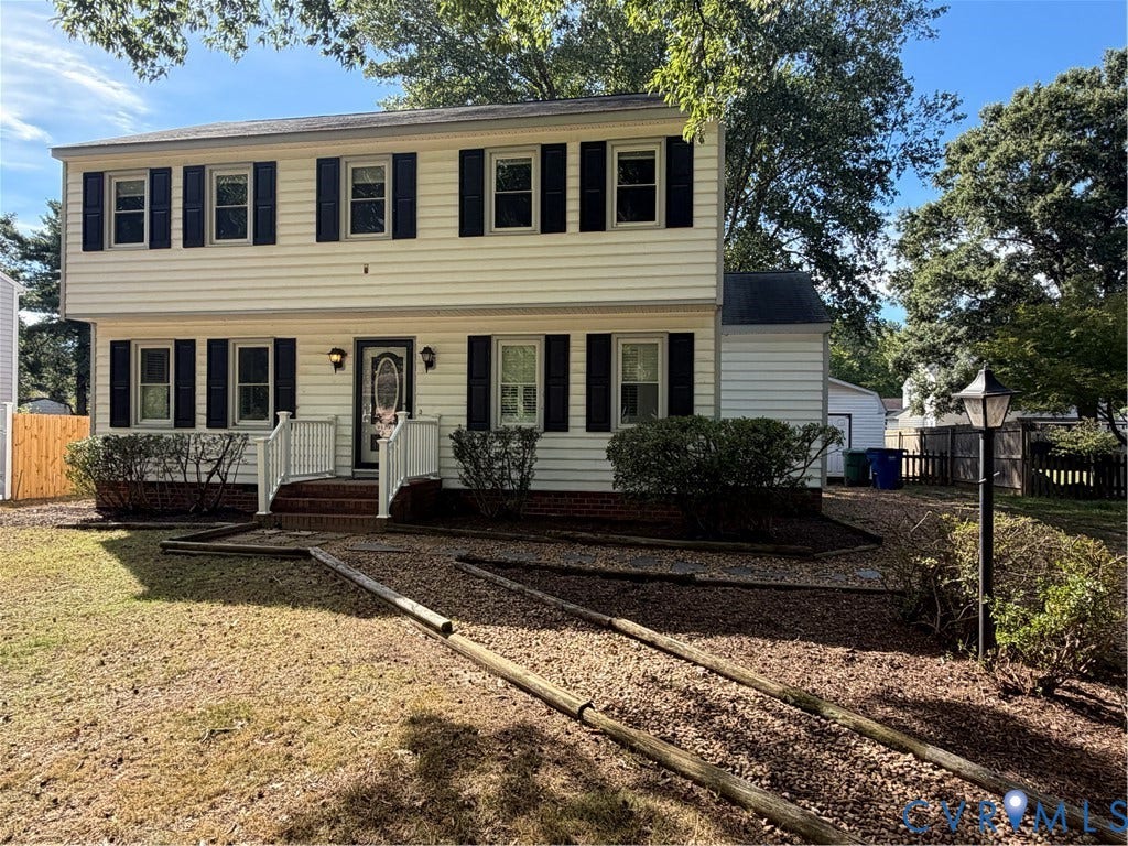 2228 Early Settlers Road, Midlothian, VA 23235 Two-story colonial exterior featuring light-colored horizontal siding, black shutters, brick foundation detailing, an entry portico with white railings, and a stand-alone outdoor lamp post
