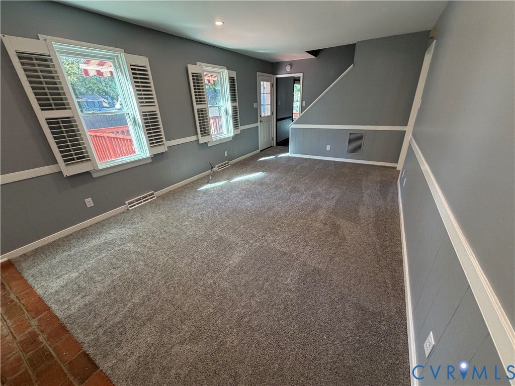 2228 Early Settlers Road, Midlothian, VA 23235 Neutral-toned interior featuring wall-to-wall carpeting, wood-finish wall paneling, white chair rail molding, and window shutters