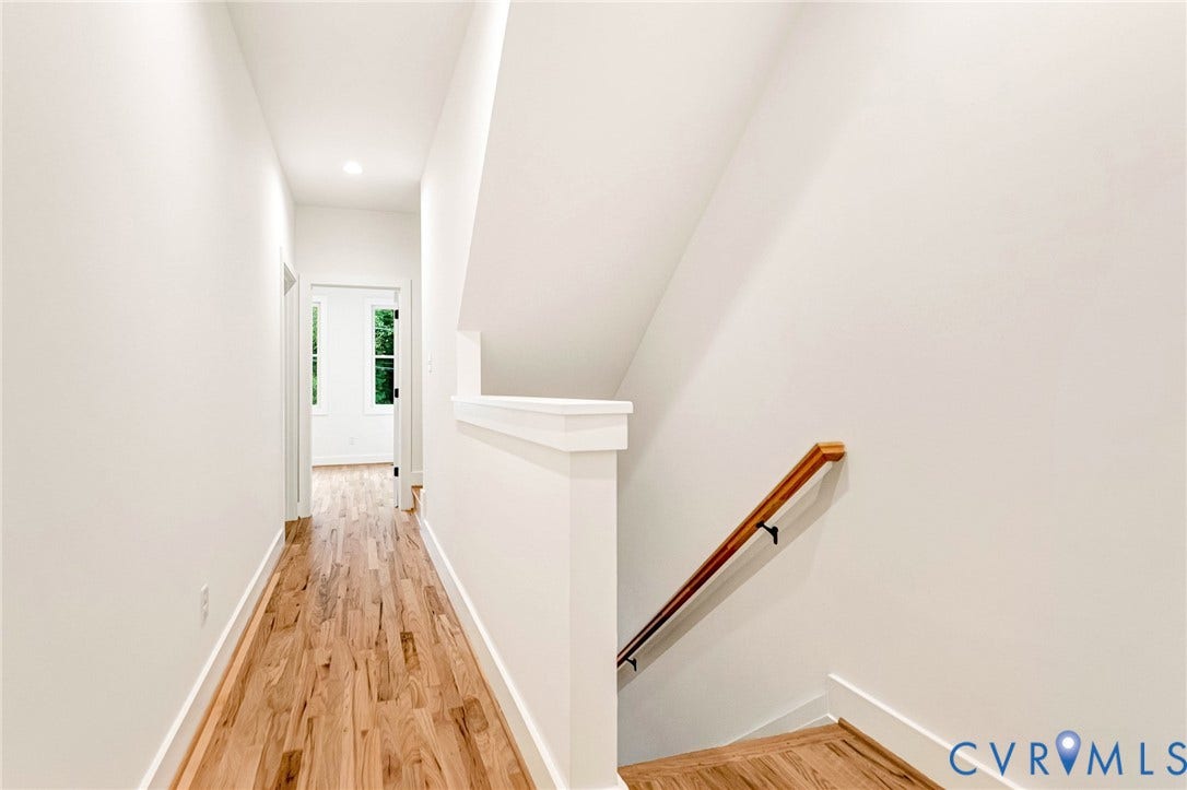 3021 E Franklin Street, St. John's Church, Richmond, VA 23223 Hallway featuring wood-finish flooring, a wall-mounted wooden handrail, and recessed lighting