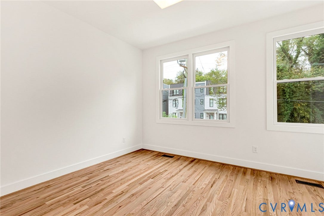 3021 E Franklin Street, St. John's Church, Richmond, VA 23223 Bright interior space featuring wood-finish flooring, crisp white walls, and dual-pane windows with exterior greenery