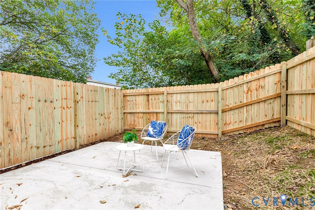 3021 E Franklin Street, St. John's Church, Richmond, VA 23223 Concrete patio enclosed by a wood privacy fence with surrounding mature trees