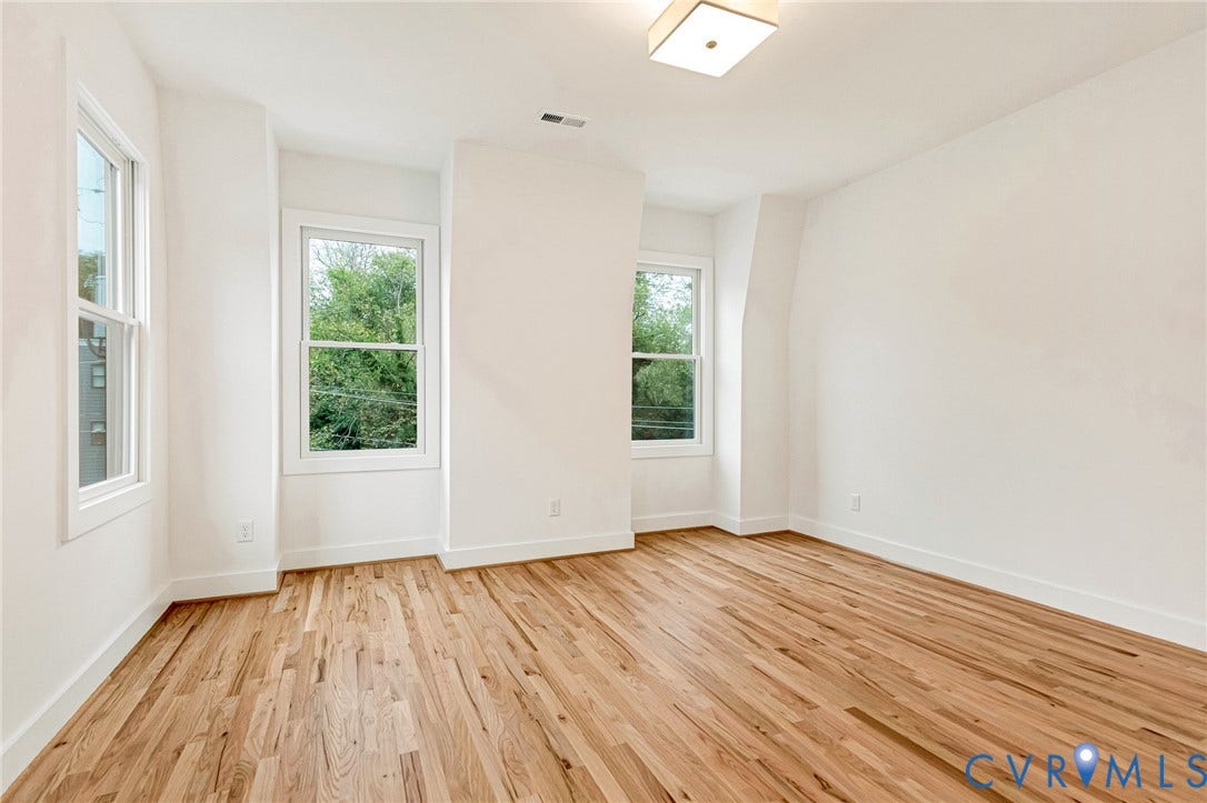 3021 E Franklin Street, St. John's Church, Richmond, VA 23223 Interior space featuring wood-finish flooring, three double-hung windows, and a flush-mount light fixture