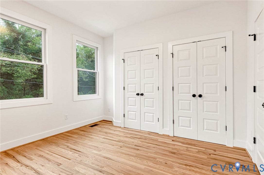 3021 E Franklin Street, St. John's Church, Richmond, VA 23223 Wood-finish flooring, dual double-door closets with matte black hardware, and two large windows with natural illumination