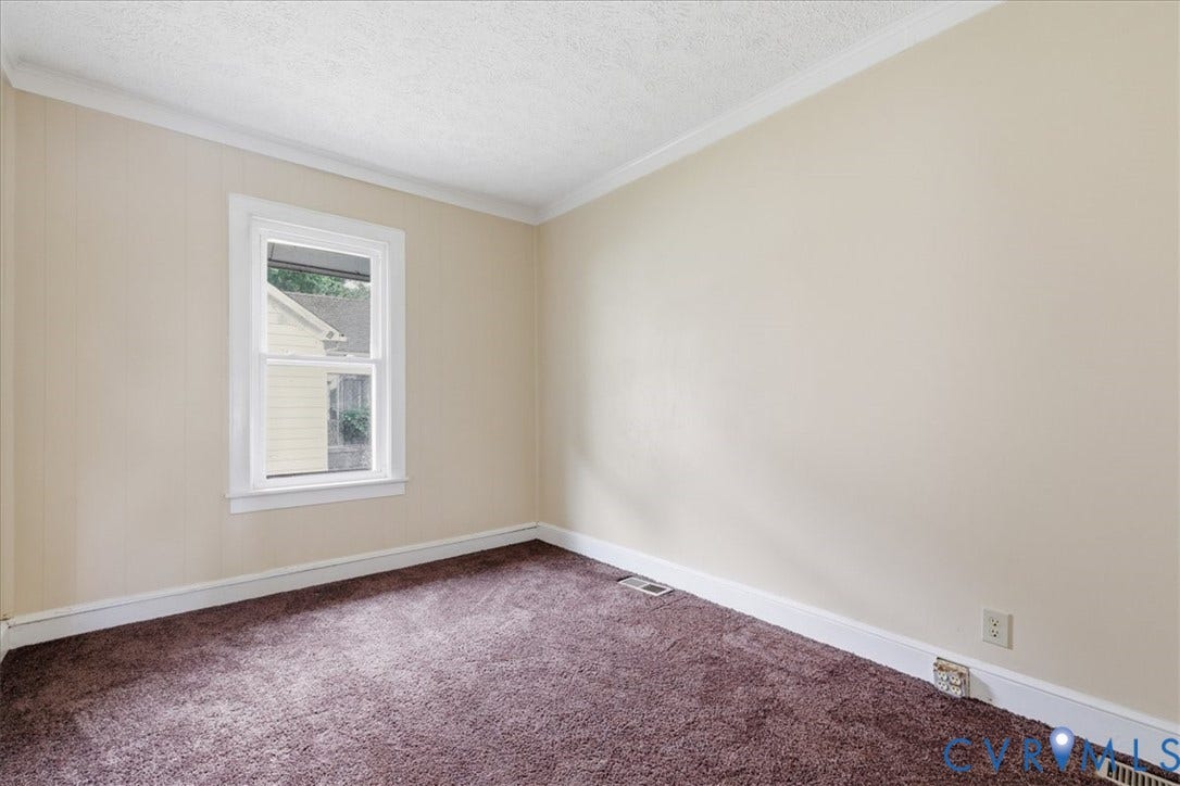 100 N 3rd Avenue, Hopewell, VA 23860 Room featuring neutral-toned walls, crown molding, double-hung window with white casing, and carpeting