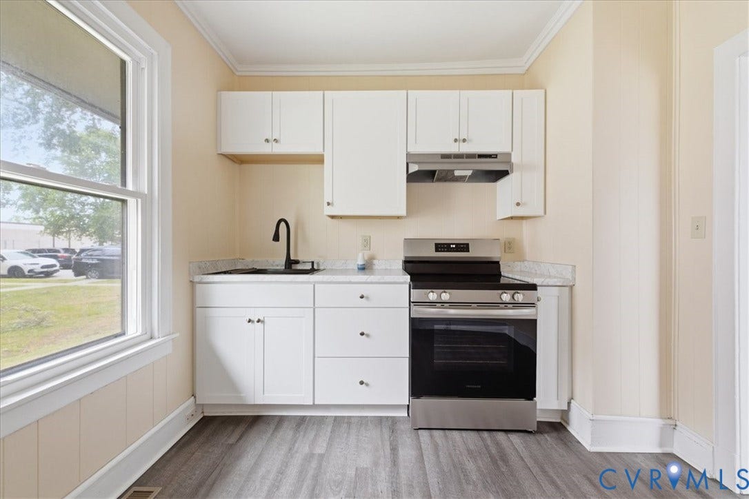 100 N 3rd Avenue, Hopewell, VA 23860 Kitchen featuring white cabinetry, stone-finish countertops, stainless steel range with overhead hood, matte black faucet, and wood-finish flooring