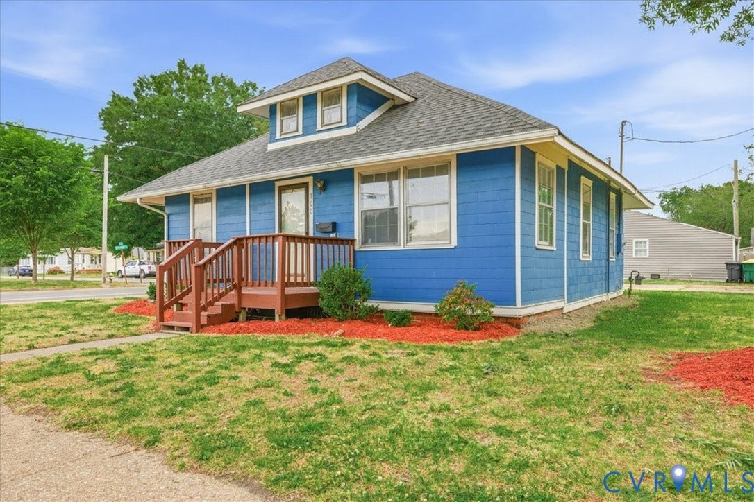 100 N 3rd Avenue, Hopewell, VA 23860 Craftsman-style residence featuring horizontal siding, a prominent front-facing dormer, a raised wooden porch with balustrade, and an asphalt shingle roof