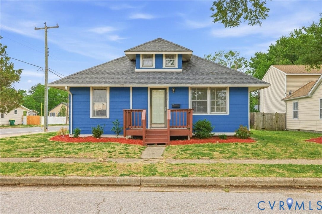 100 N 3rd Avenue, Hopewell, VA 23860 Single-story exterior featuring lap siding, a roof dormer, shingled roofing, and a wooden front porch