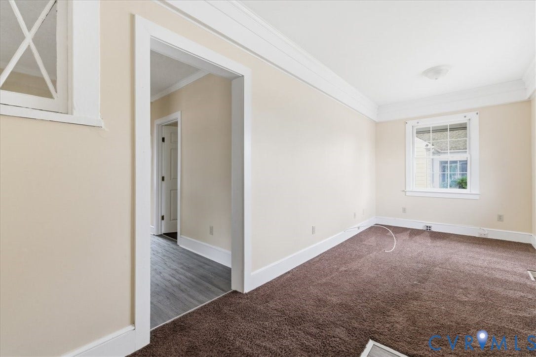 100 N 3rd Avenue, Hopewell, VA 23860 Interior space featuring crown molding, neutral wall finishes, sash windows, and carpeted flooring