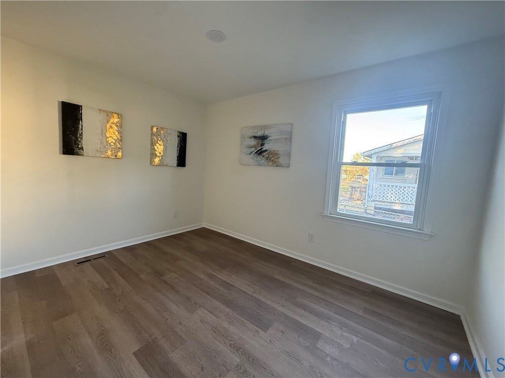 120 N New Avenue, Henrico, VA 23075 Interior space featuring neutral wall paint, wood-finish flooring, and a single-hung window with white casing