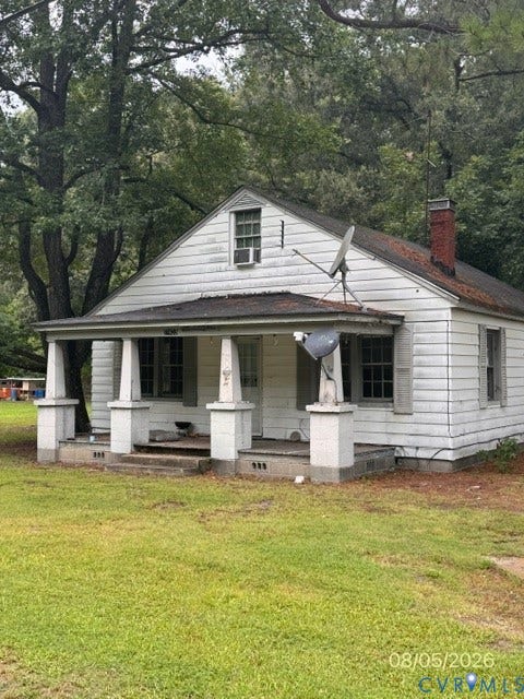 17403 Pittman Road, Beaton Add, Boykins, VA 23827 Single-story residence featuring white siding, a covered front porch with stone-style piers, and a brick chimney