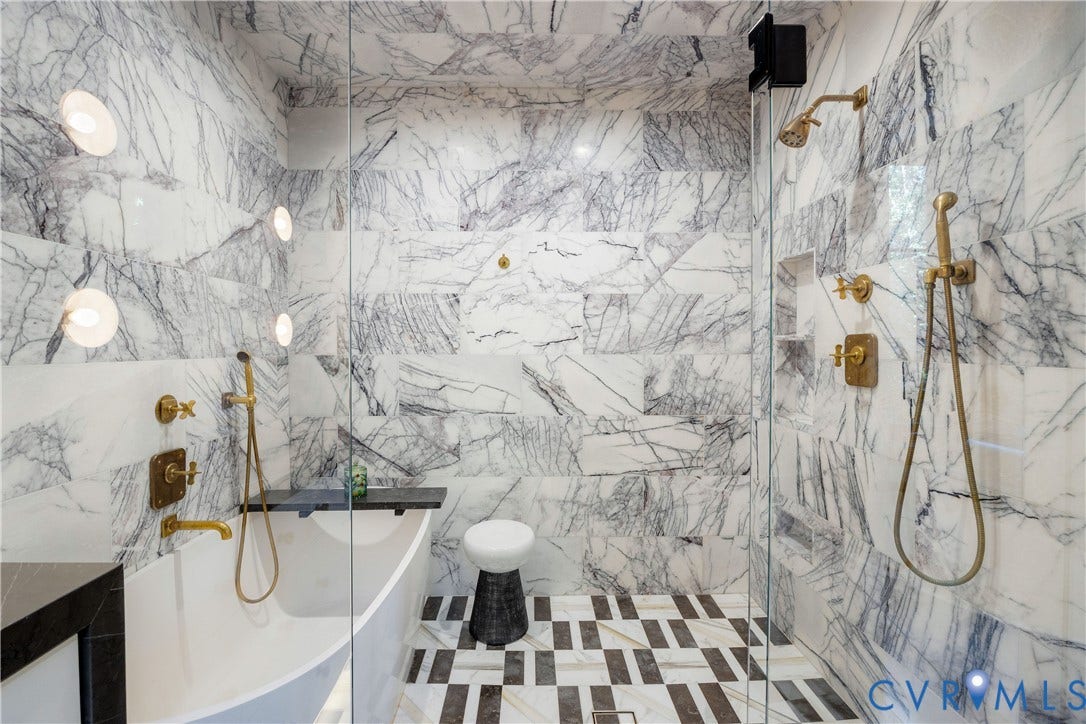 301 Lock Lane, Windsor Farms, Richmond, VA 23226 A glass-enclosed shower in lilac marble holds both the soaking tub and the shower, with Waterworks fittings and a heated floor.