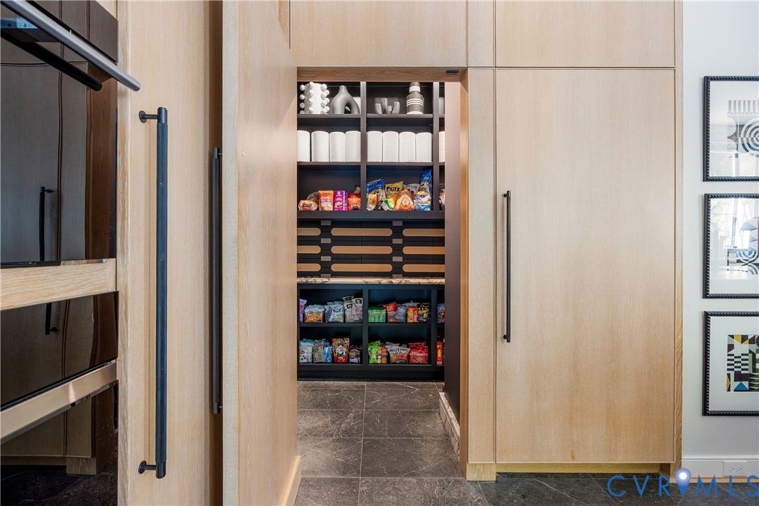 301 Lock Lane, Windsor Farms, Richmond, VA 23226 Walk-in pantry behind flush white oak panels, with Calacatta Viola counters and baseboards and a Jamie Beckwith white oak backsplash.