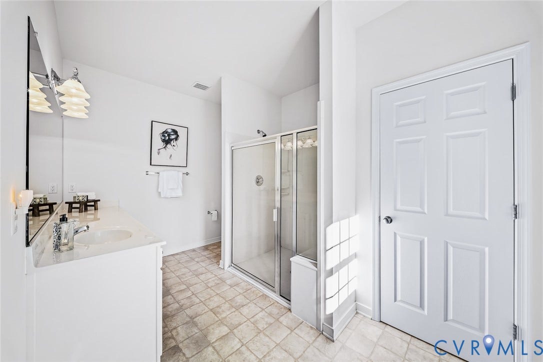 Primary Bathroom with Walk-in shower featuring a glass enclosure and  linen closet