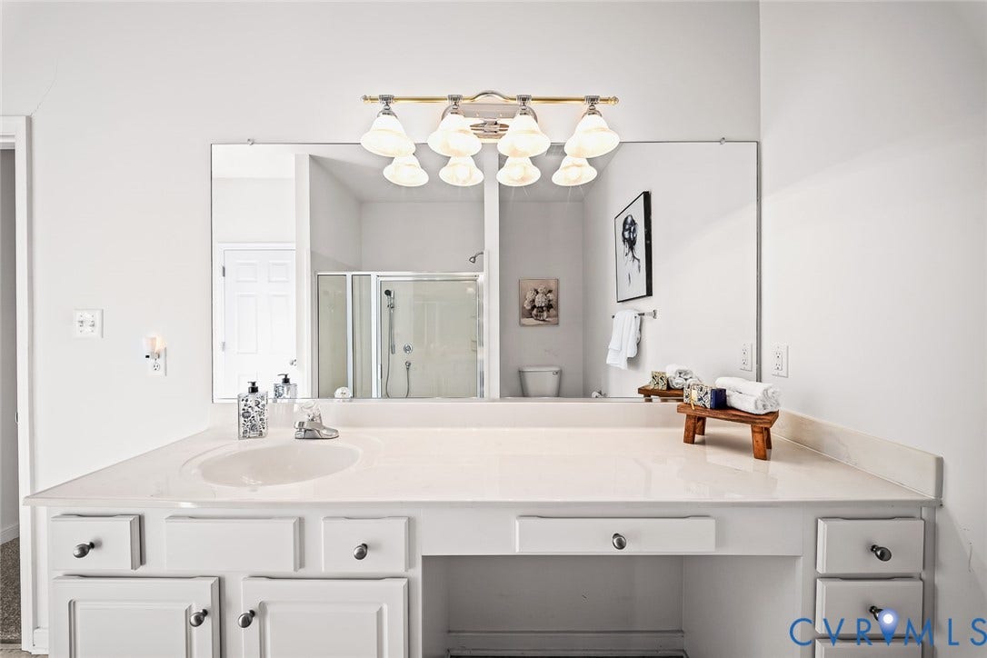 Primary Bathroom with Walk-in shower featuring a glass enclosure and  linen closet