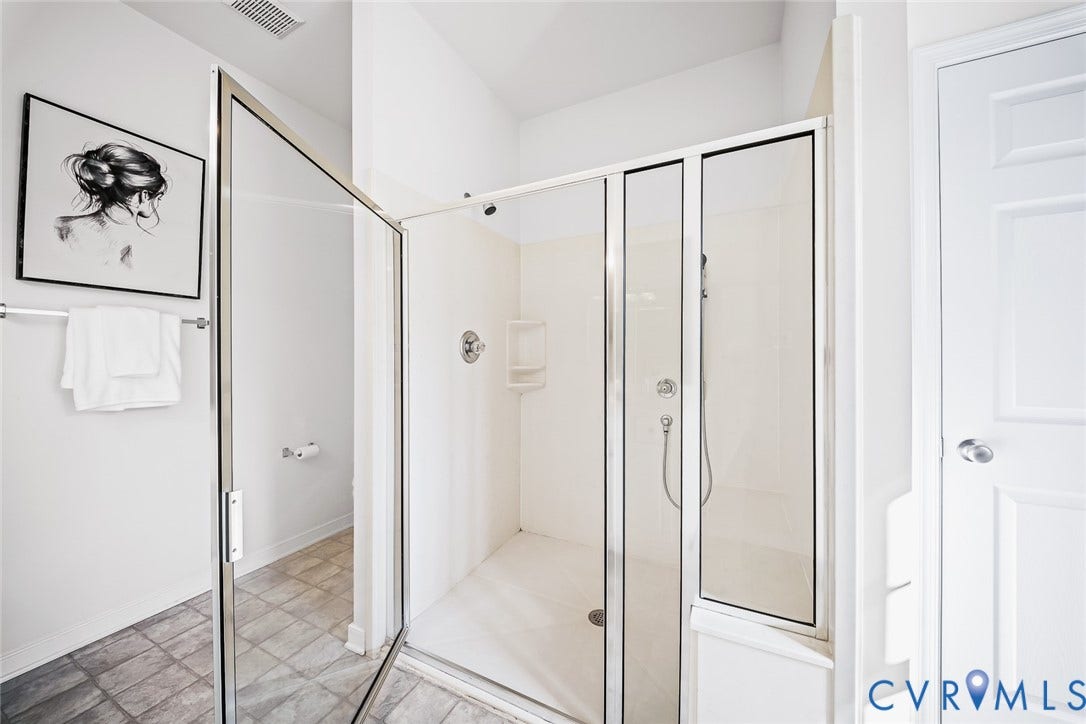 Primary Bathroom with Walk-in shower featuring a glass enclosure and  linen closet