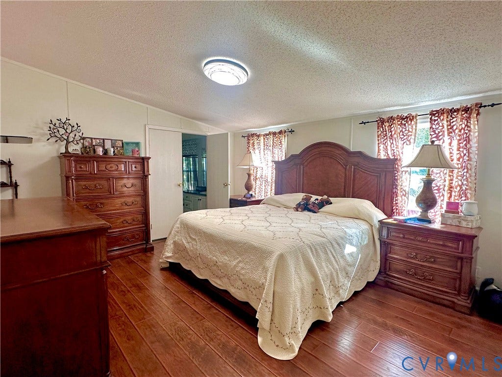 25400 SAYLERS CREEK ROAD, Deatonville, Jetersville, VA 23083 Room featuring wood-finish flooring, textured ceiling, flush-mount lighting, and dual windows