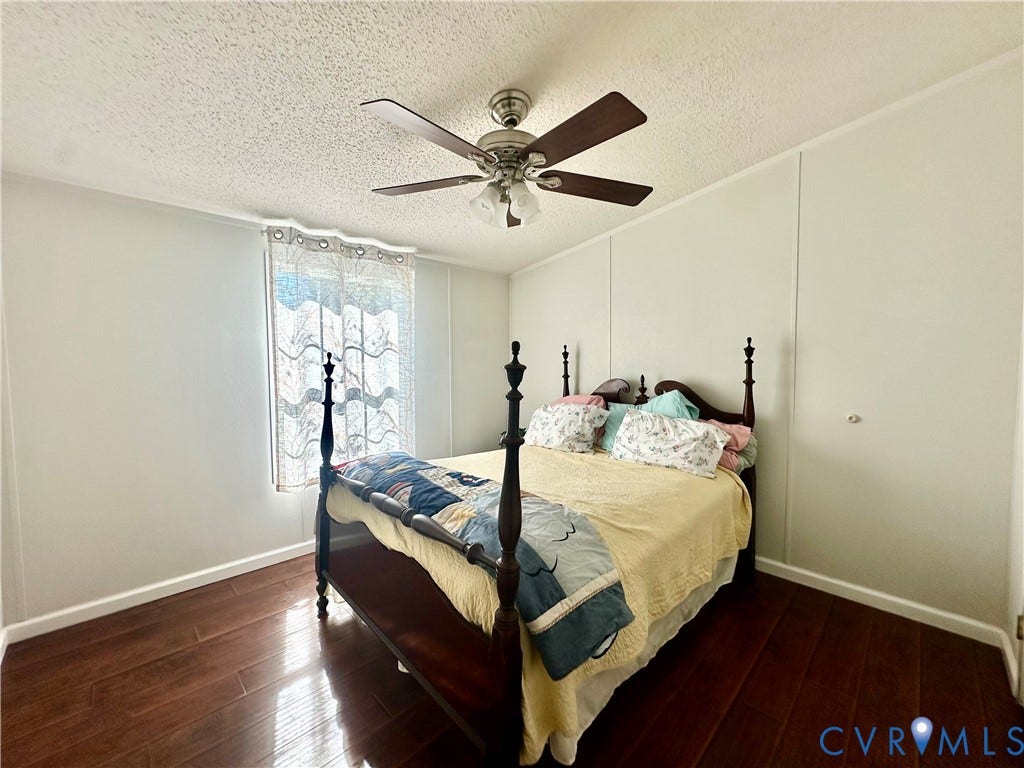 25400 SAYLERS CREEK ROAD, Deatonville, Jetersville, VA 23083 Room featuring wood-finish flooring, a ceiling fan with integrated lighting, and a window with textured pane detailing