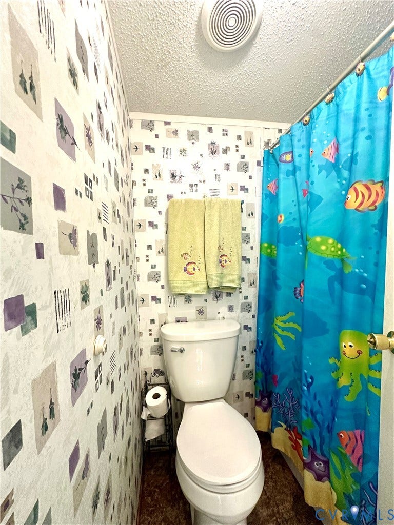 25400 SAYLERS CREEK ROAD, Deatonville, Jetersville, VA 23083 Bathroom featuring a standard white porcelain toilet, ceiling-mounted ventilation fan, and textured ceiling