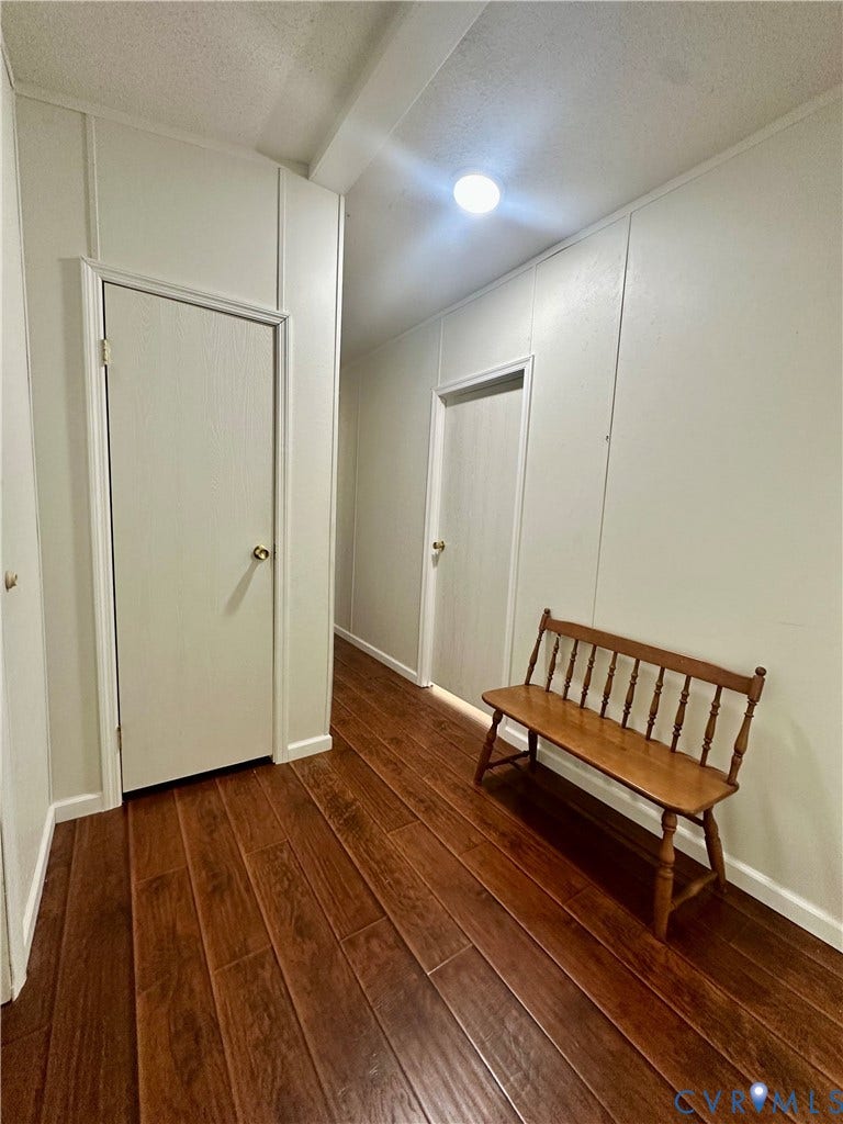 25400 SAYLERS CREEK ROAD, Deatonville, Jetersville, VA 23083 Interior corridor featuring wood-finish flooring, paneled wall detailing, and flush-mount ceiling lighting