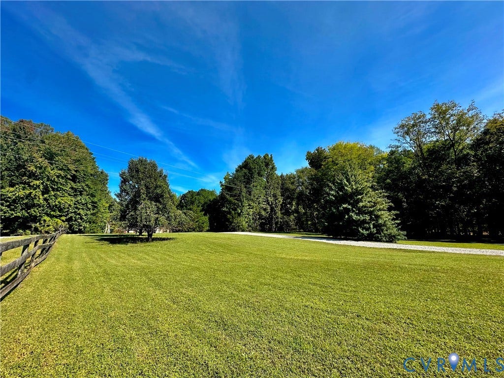 25400 SAYLERS CREEK ROAD, Deatonville, Jetersville, VA 23083 Expansive lot featuring a manicured lawn, perimeter split-rail fencing, a gravel driveway, and mature trees