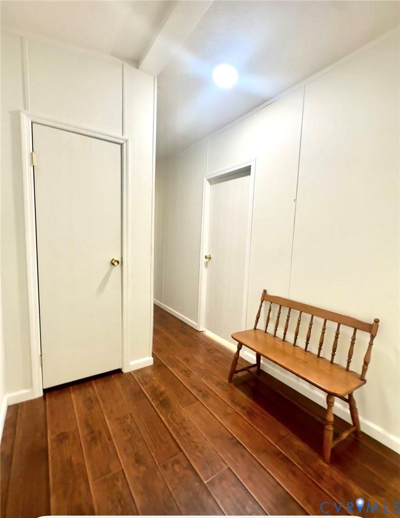 25400 SAYLERS CREEK ROAD, Deatonville, Jetersville, VA 23083 Hallway featuring wood-finish flooring, white paneled walls, and interior doors with brass-tone hardware