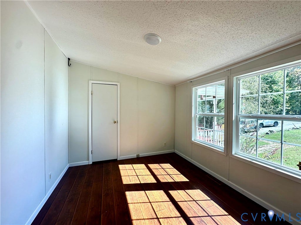 25400 SAYLERS CREEK ROAD, Deatonville, Jetersville, VA 23083 Interior room featuring wood-finish flooring, dual grid-pattern windows, and a flush-mount ceiling light fixture