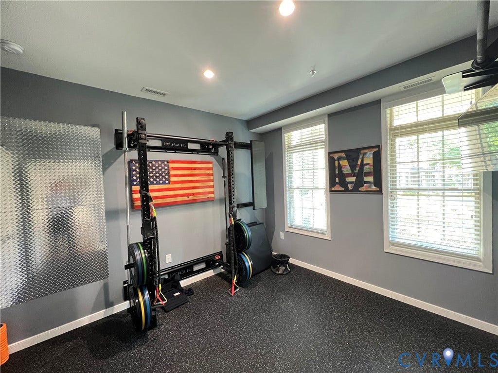 2310 Liesfeld Parkway, West Broad Village, Henrico, VA 23060 Room featuring dark speckled rubber flooring, recessed ceiling lighting, two double-hung windows with integrated blinds, and diamond-plate metal wall paneling
