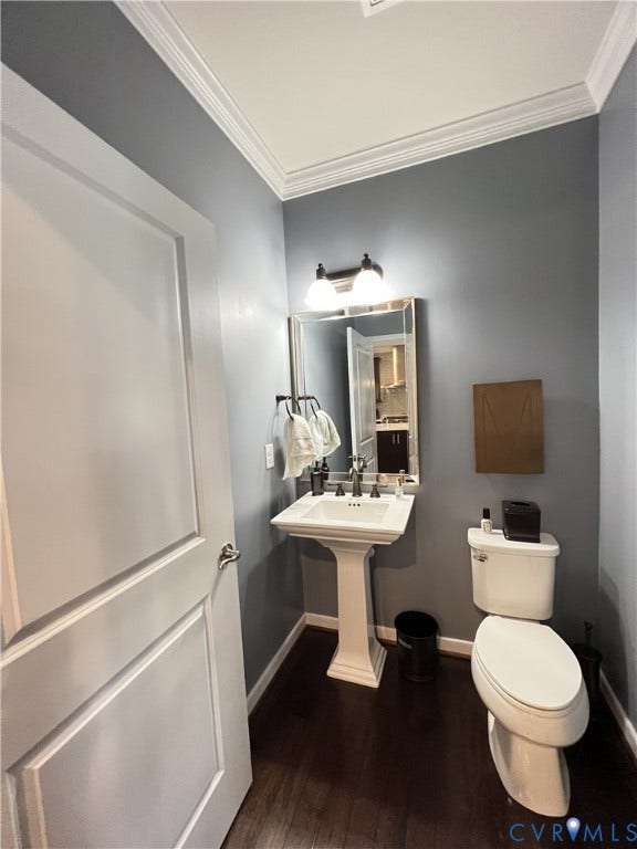2310 Liesfeld Parkway, West Broad Village, Henrico, VA 23060 Pedestal sink with widespread metal faucet, framed rectangular mirror, crown molding, and wood-finish flooring