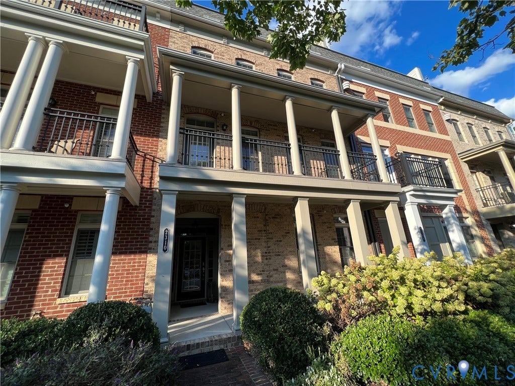 2310 Liesfeld Parkway, West Broad Village, Henrico, VA 23060 Multi-story brick exterior featuring a covered porch with classical columns, a second-story balcony with decorative metal railing, and a multi-pane glass entry door