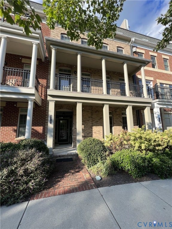 2310 Liesfeld Parkway, West Broad Village, Henrico, VA 23060 Multi-story brick exterior featuring a covered front porch with classic columns, second-level railed balcony, and decorative brick masonry detail