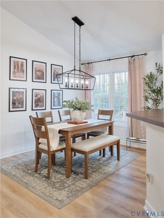 444 Tillar Lane, Mineral, VA 23117 Dining area featuring vaulted ceilings, wood-finish flooring, and a multi-light geometric chandelier