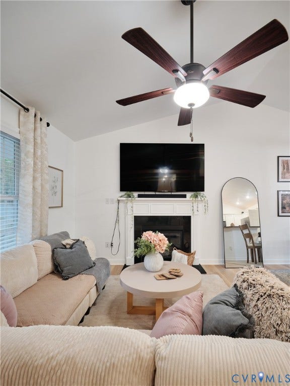 444 Tillar Lane, Mineral, VA 23117 Vaulted ceilings, white fireplace mantle, dark-finish ceiling fan with integrated lighting, and neutral wall tones