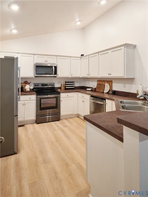 444 Tillar Lane, Mineral, VA 23117 Kitchen featuring white cabinetry, solid-surface countertops, stainless steel appliances, and wood-finish flooring