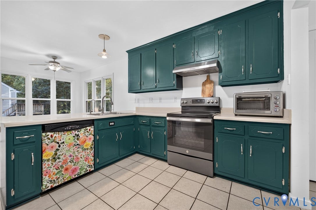 7225 Hartsdale Court, Chesterfield, VA 23832 Virtually-staged Kitchen featuring dark teal cabinetry, solid-surface countertop with integrated sink, large-format tile flooring, and double-hung windows