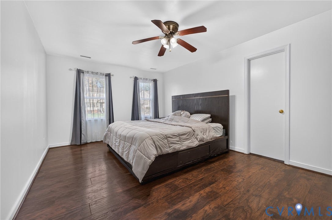 7225 Hartsdale Court, Chesterfield, VA 23832 Room featuring wood-finish flooring, dual windows, and a multi-blade ceiling fan with integrated lighting