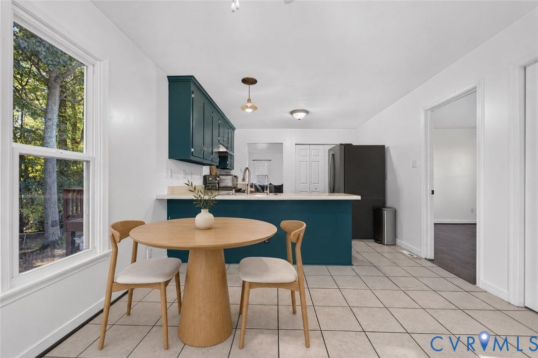 7225 Hartsdale Court, Chesterfield, VA 23832 Virtually-staged Kitchen featuring dark teal cabinetry, solid-surface countertop with integrated sink, large-format tile flooring, and double-hung windows