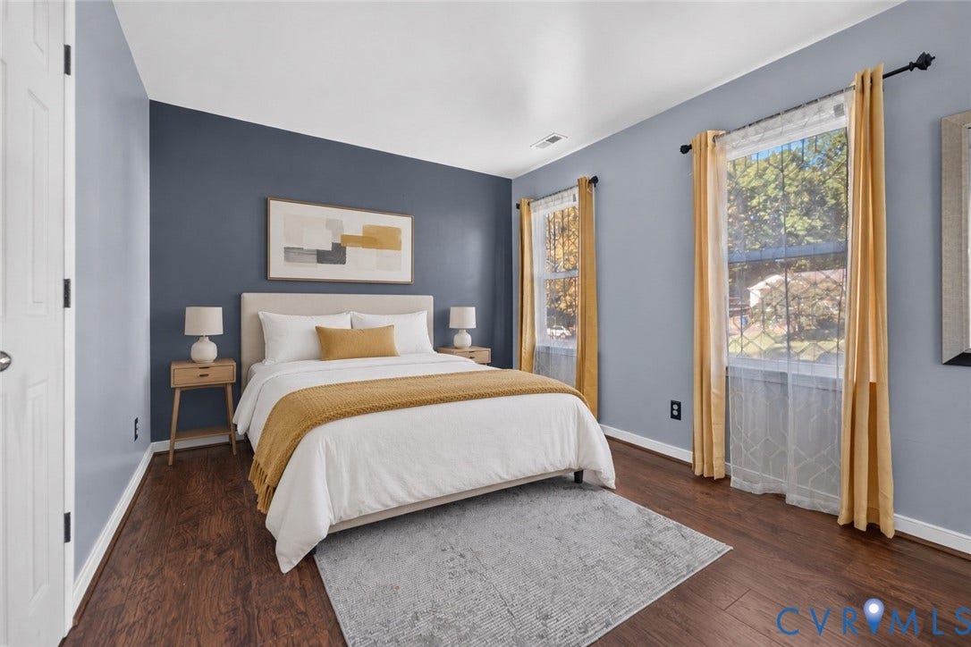 7225 Hartsdale Court, Chesterfield, VA 23832 virtually-staged Room featuring wood-finish flooring, dual windows with decorative hardware, and a dark-toned accent wall