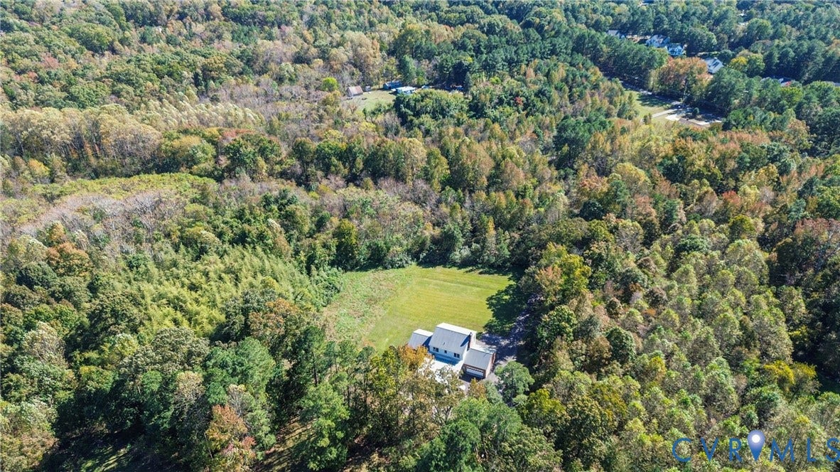 13225 Old Happy Hill Road, Chester, VA 23831 Aerial perspective of a multi-level residence situated on a parcel featuring expansive cleared grounds and extensive surrounding woodland