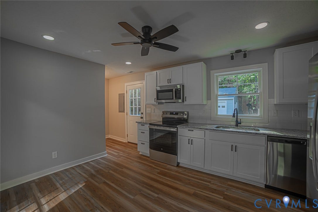 Kitchen featuring white cabinetry, stone-finish countertops, stainless steel appliances, wood-finish flooring, and recessed lighting