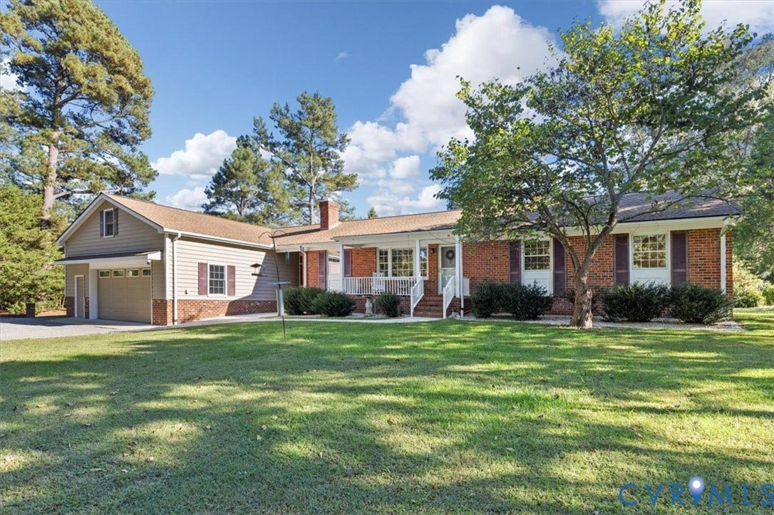 5111 Hurop Road, Sandston, VA 23150 Brick exterior with horizontal siding, covered front porch, attached garage, and mature trees on a landscaped lot