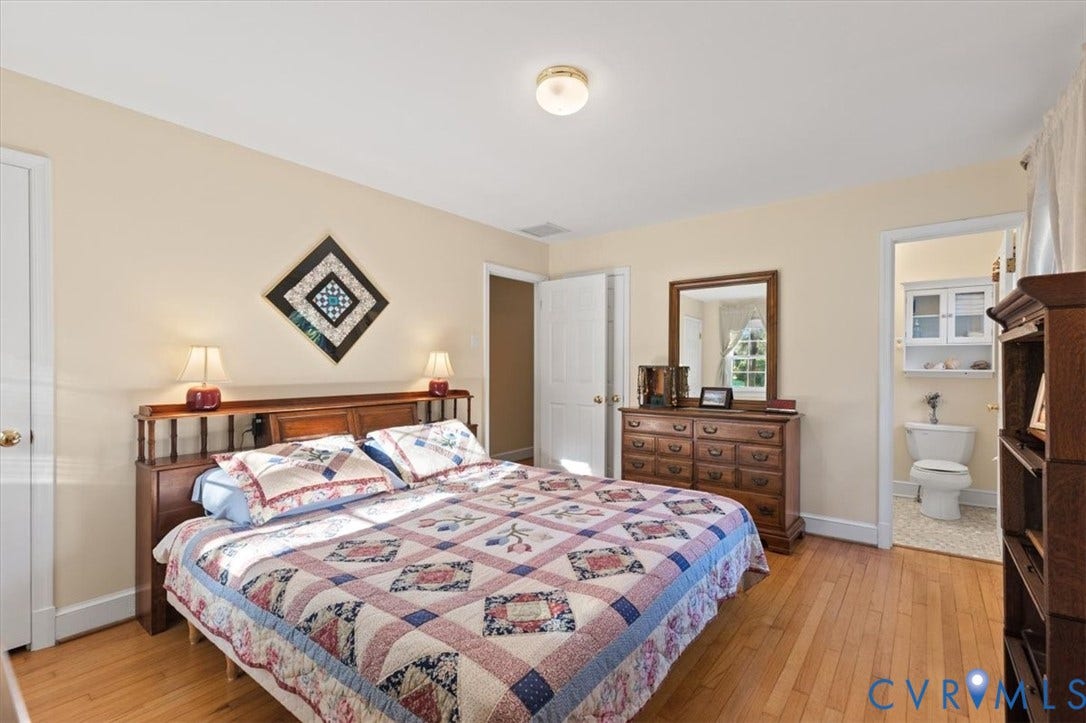 5111 Hurop Road, Sandston, VA 23150 Bedroom featuring natural wood-finish flooring, six-panel interior doors, and a ceiling-mounted flush light fixture