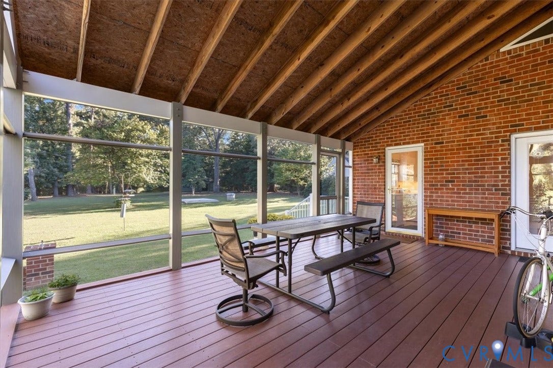5111 Hurop Road, Sandston, VA 23150 Screened porch featuring exposed rafter ceiling, red brick wall, wood-finish flooring, and full-height screens